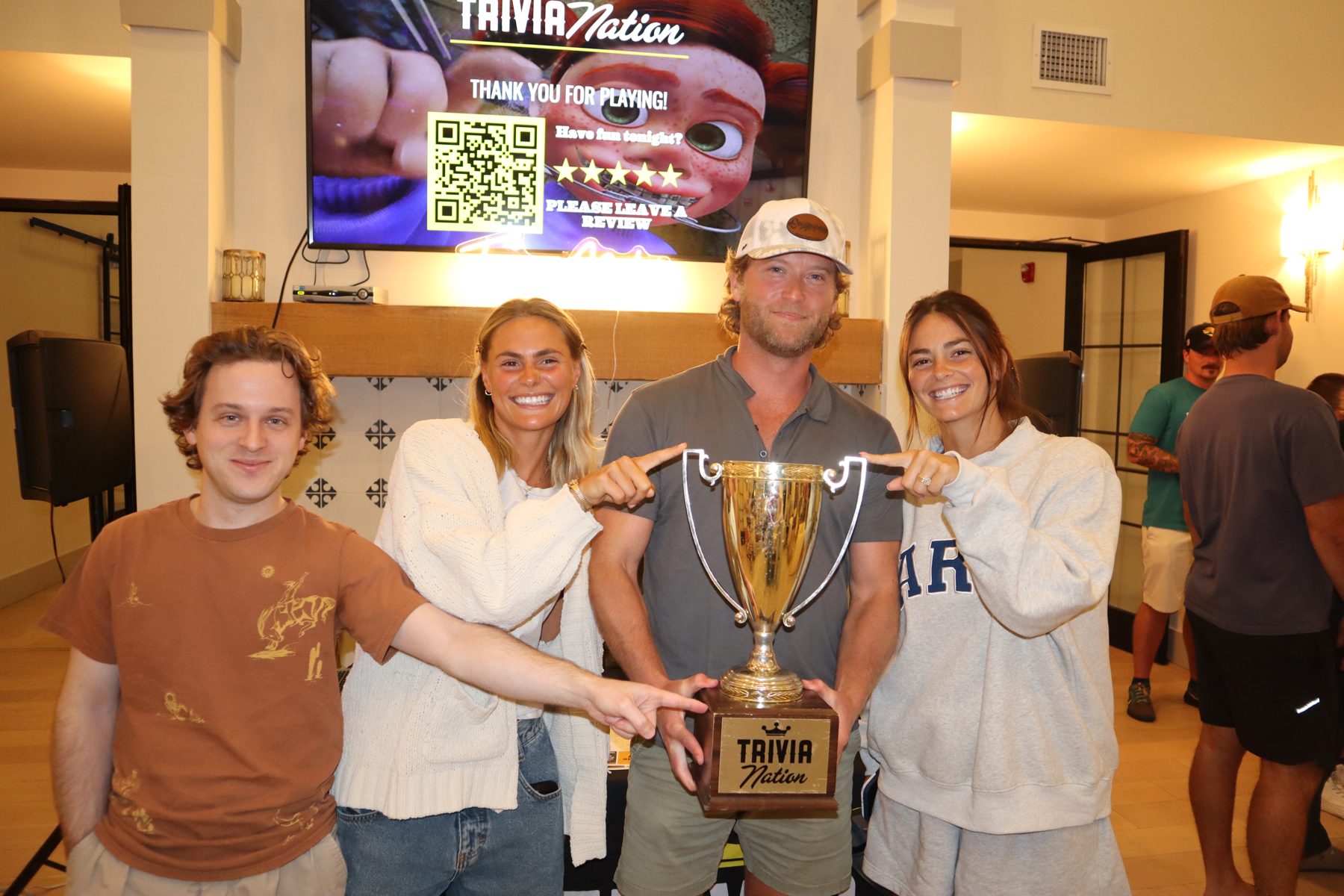 Trophy winners posing with the Trivia Nation host